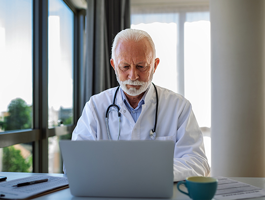 Doctor taking notes on laptop